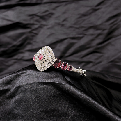 Bracelet with ruby gemstones and AD circular centre piece on a black textured fabric background