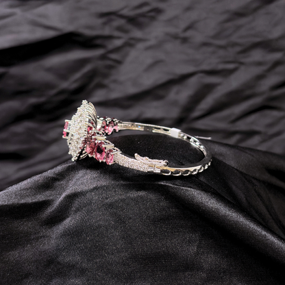 Bracelet with ruby gemstones and AD circular centre piece on a black textured fabric background
